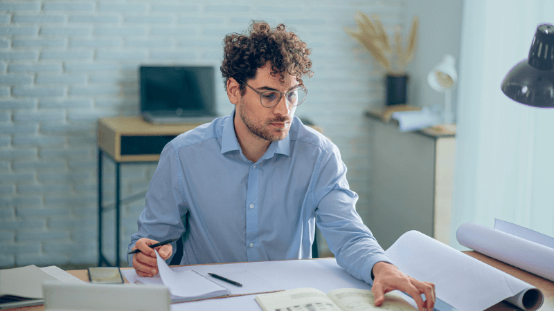Patent And Trademark Attorney Recruitment Legal Professional Reviewing Technical Documents In An Office, Representing Patent And Trademark Attorney Recruitment.