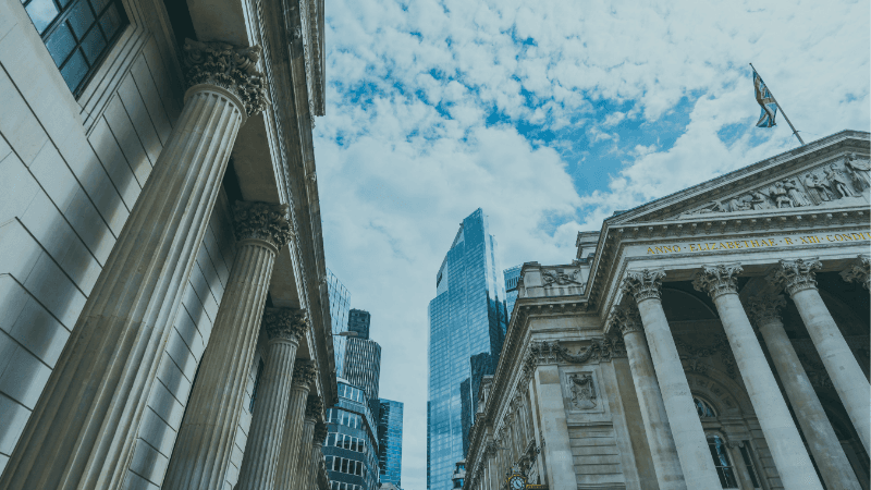 London Legal And Financial District Architecture, With Classical Columns And Modern Office Buildings Representing UK Legal Salary Benchmarking.