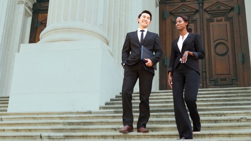General Counsel Professionals Walking Down A Set Of Stairs