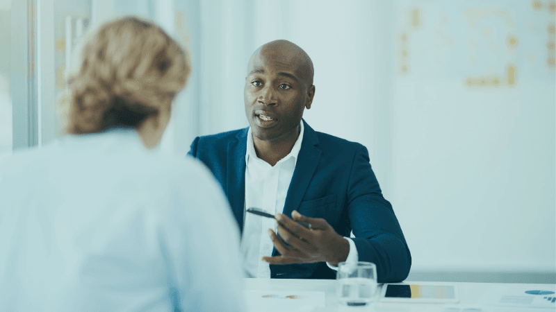 General Counsel Discussing Compensation And Career Progression During A Business Meeting.