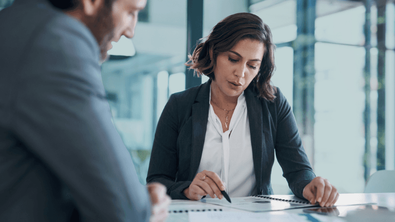 Contracts And Operations Recruitment Legal Professionals Reviewing Contract Documents In A Modern Office, Representing Legal Operations And Contracts Recruitment.